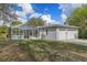 The home's backyard features a screened pool, lush grass, and a two-car garage at 16411 County Road 675, Parrish, FL 34219