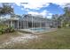 Spacious lawn with a screened pool, offering a private backyard oasis for relaxation and enjoyment at 16411 County Road 675, Parrish, FL 34219