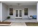 Inviting front porch with double doors, a ceiling fan, and outdoor seating at 16411 County Road 675, Parrish, FL 34219