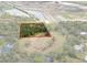 Aerial view of the acreage of land, outlined in red, that is densely wooded in the center at 16411 County Road 675, Parrish, FL 34219