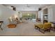 Bright and spacious living room with a wall of windows overlooking the pool and outdoor dining area at 16411 County Road 675, Parrish, FL 34219
