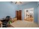 Bright office space with blue walls, built-in bookshelves, and doorway to the main living area at 16411 County Road 675, Parrish, FL 34219