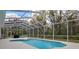 Screened-in pool area surrounded by lush greenery offering a private retreat at 16411 County Road 675, Parrish, FL 34219