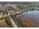Scenic aerial shot of a waterfront apartment overlooking the beautiful coastline and clear waters at 1723 Gulf Rd # 104, Tarpon Springs, FL 34689