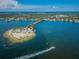 Beautiful island features tropical palm trees, sandy beach, picnic shelters and boaters enjoying sunny day at 1723 Gulf Rd # 104, Tarpon Springs, FL 34689