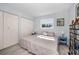 Bright bedroom with closet, window, and blue side tables, creating a serene and inviting space at 1723 Gulf Rd # 104, Tarpon Springs, FL 34689