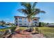 Condo building exterior with lush landscaping and outdoor seating area, perfect for relaxation at 1723 Gulf Rd # 104, Tarpon Springs, FL 34689