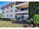 Attractive exterior featuring balconies, offering stunning waterfront views, with lush landscaping and a tranquil setting at 1723 Gulf Rd # 104, Tarpon Springs, FL 34689