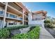 Charming exterior view of the apartment building with well-maintained landscaping and a welcoming entrance at 1723 Gulf Rd # 104, Tarpon Springs, FL 34689