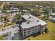 Exterior view of a multi-story residential building with a parking area and well-maintained landscaping at 1723 Gulf Rd # 104, Tarpon Springs, FL 34689