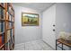 Inviting hallway featuring a built-in bookcase and tiled floor at 1723 Gulf Rd # 104, Tarpon Springs, FL 34689