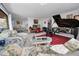 Open living space showcasing a grand piano, comfortable seating, and dining area at 1723 Gulf Rd # 104, Tarpon Springs, FL 34689