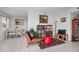 Cozy living room with tile flooring, artwork, and dining space at 1723 Gulf Rd # 104, Tarpon Springs, FL 34689