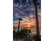 Beautiful sunset scenery along the shoreline with swaying palm trees and calm waters under a picturesque sky at 1723 Gulf Rd # 104, Tarpon Springs, FL 34689