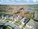 Aerial view of the property showcasing a serene neighborhood, lush trees and beautiful lake views at 18629 Coastal Shore Ter, Land O Lakes, FL 34638