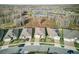 Aerial view of a neighborhood with well-maintained homes, green spaces, and a tranquil pond at 18629 Coastal Shore Ter, Land O Lakes, FL 34638