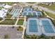 Aerial view of the community's tennis courts, bocce ball area, parking, and community amenities at 18629 Coastal Shore Ter, Land O Lakes, FL 34638