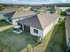Aerial view of the backyard featuring a screened lanai and an outdoor dining set with an umbrella at 18629 Coastal Shore Ter, Land O Lakes, FL 34638