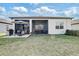 Spacious backyard with a screened-in lanai and a patio area, perfect for outdoor entertaining and relaxation at 18629 Coastal Shore Ter, Land O Lakes, FL 34638