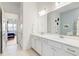 Bright bathroom with a double sink vanity, quartz countertop and modern lighting at 18629 Coastal Shore Ter, Land O Lakes, FL 34638