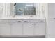 Bright bathroom with a double sink vanity, quartz countertop and modern fixtures at 18629 Coastal Shore Ter, Land O Lakes, FL 34638