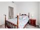 Cozy bedroom featuring a wood-framed bed with a floral comforter and wood laminate flooring at 18629 Coastal Shore Ter, Land O Lakes, FL 34638