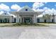Stately community clubhouse featuring a grand entrance and covered portico, offering a welcoming space at 18629 Coastal Shore Ter, Land O Lakes, FL 34638