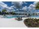 Inviting community pool area with shaded seating, perfect for relaxing and socializing with neighbors at 18629 Coastal Shore Ter, Land O Lakes, FL 34638