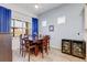 Eat-in dining area featuring wood furnishings, bright blue curtains, and built in wine storage at 18629 Coastal Shore Ter, Land O Lakes, FL 34638