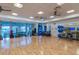Spacious fitness center featuring wood floors, exercise equipment, weights, and ceiling fans at 18629 Coastal Shore Ter, Land O Lakes, FL 34638