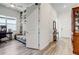 Hallway leading to a room with a desk, couch, and built-in bookshelves, enhancing functionality and style at 18629 Coastal Shore Ter, Land O Lakes, FL 34638