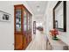 Hallway featuring wood floors, a china cabinet, and stylish decor, creating an inviting and elegant ambiance at 18629 Coastal Shore Ter, Land O Lakes, FL 34638