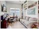 Well-lit home office featuring custom built-ins, neutral paint, hardwood floors and a large window at 18629 Coastal Shore Ter, Land O Lakes, FL 34638