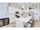 Bright, white kitchen with quartz counters, stainless steel appliances, large island and wine storage at 18629 Coastal Shore Ter, Land O Lakes, FL 34638