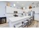 Modern kitchen with white cabinets, stainless steel appliances, large island, and seating, perfect for Gathering gatherings at 18629 Coastal Shore Ter, Land O Lakes, FL 34638