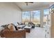 A screened lanai with beautiful outdoor views, comfortable seating, ceiling fan, and lots of natural light at 18629 Coastal Shore Ter, Land O Lakes, FL 34638