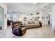 Open-concept living room, adjacent to the kitchen, featuring wood floors and ample natural light at 18629 Coastal Shore Ter, Land O Lakes, FL 34638