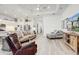 Bright and spacious living room with an open floor plan, seamlessly connecting to the modern kitchen at 18629 Coastal Shore Ter, Land O Lakes, FL 34638