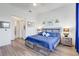 Bright and airy main bedroom with a large window, modern decor, and wood flooring at 18629 Coastal Shore Ter, Land O Lakes, FL 34638