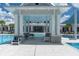 Relaxing poolside cabana with comfortable seating overlooking the pool and community center at 18629 Coastal Shore Ter, Land O Lakes, FL 34638