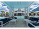 Stylish poolside lounge area with comfortable sofas and tables, ideal for relaxing and entertaining at 18629 Coastal Shore Ter, Land O Lakes, FL 34638
