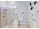 Modern bathroom featuring a glass-enclosed shower with tiled walls and a built-in seat at 18629 Coastal Shore Ter, Land O Lakes, FL 34638