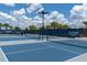 Community tennis courts featuring professional-grade surfaces, nets, and fencing for an enjoyable match at 18629 Coastal Shore Ter, Land O Lakes, FL 34638