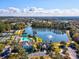 Aerial view highlighting Southern Hills amenities, including a pool, tennis courts, and scenic lake at 19504 Lily Pond Ct, Brooksville, FL 34601
