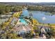 A stunning aerial view of Southern Hills amenities and lake; tennis courts, pool and clubhouse at 19504 Lily Pond Ct, Brooksville, FL 34601