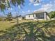 Backyard with a screened patio on a sunny day at 19504 Lily Pond Ct, Brooksville, FL 34601
