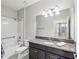 Bathroom featuring tiled shower/tub combination, granite countertop and dark cabinets at 19504 Lily Pond Ct, Brooksville, FL 34601