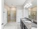 Bathroom featuring walk-in shower and granite double vanity at 19504 Lily Pond Ct, Brooksville, FL 34601