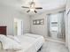 Bedroom featuring a ceiling fan, and window with patterned drapes at 19504 Lily Pond Ct, Brooksville, FL 34601