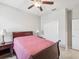 Bedroom featuring a ceiling fan, window, and tiled floors at 19504 Lily Pond Ct, Brooksville, FL 34601